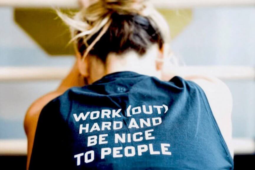 Image of someone wearing a shirt that says Work (Out) Hard and Be Nice To People